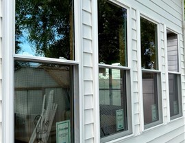 New ProVia vinyl windows installed on white siding home with 20-year glass and seal warranty