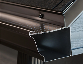 Close-up of premium gutter guard system showing perforated leaf protection installed on New Jersey home