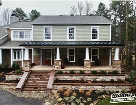 Vinyl siding and stone exterior renovation on New Jersey home with full front porch by Warner Exteriors