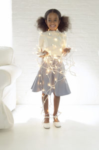 Portrait of a Young Girl Wrapped in Christmas Lights