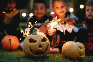 Cleveland fall activities - children carving Halloween pumpkins and holding sparklers