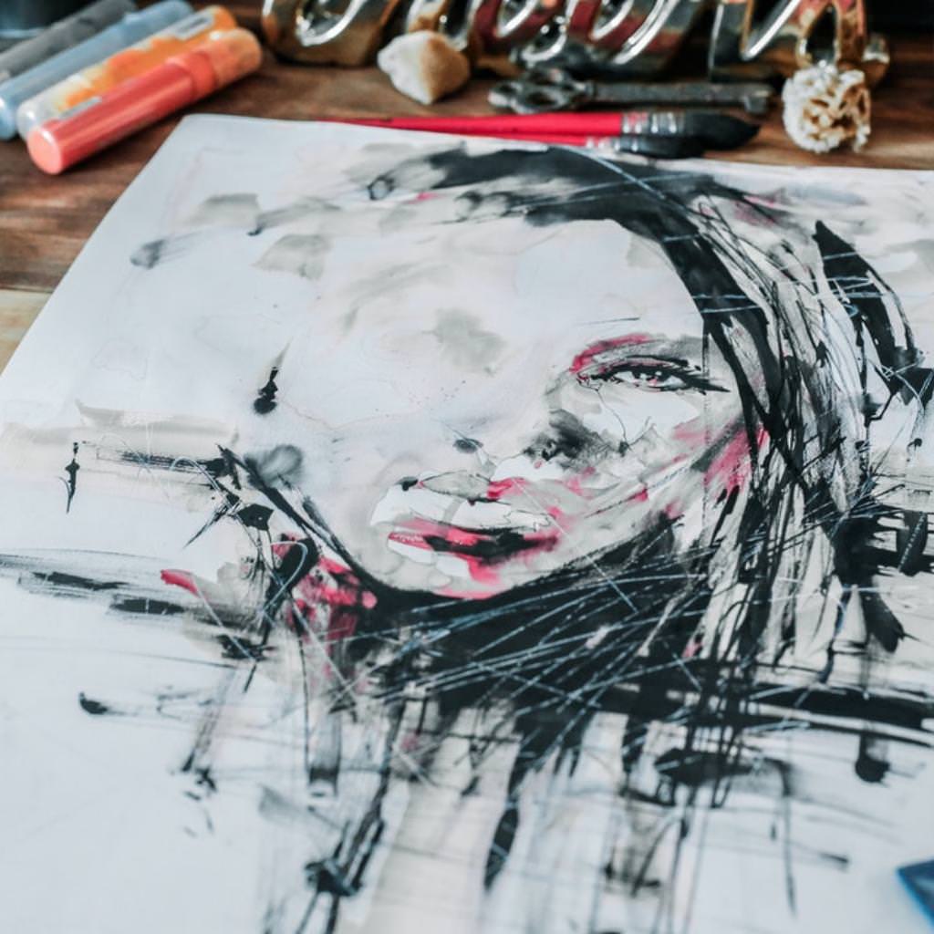 Canvas painting of a woman with art supplies