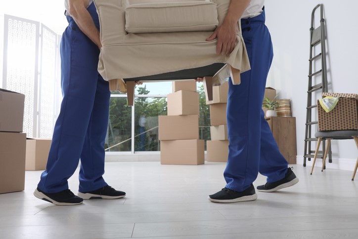 2 professional movers moving a sofa