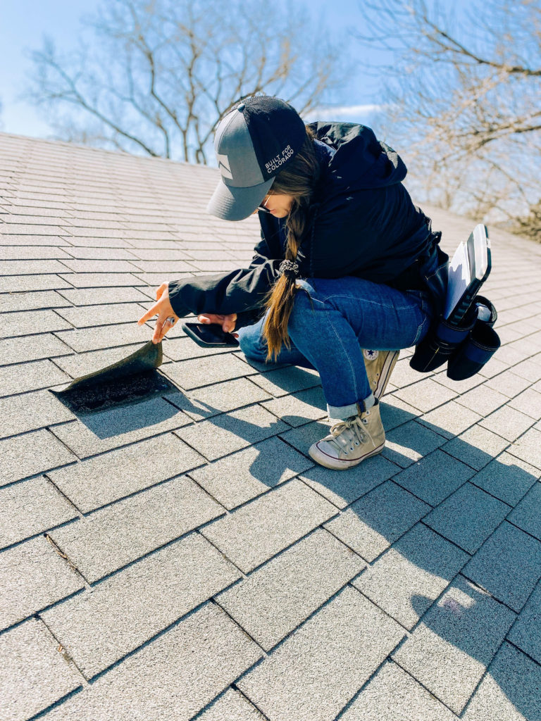 Westpro project consultant inspects a shingle for a roof insurance claim
