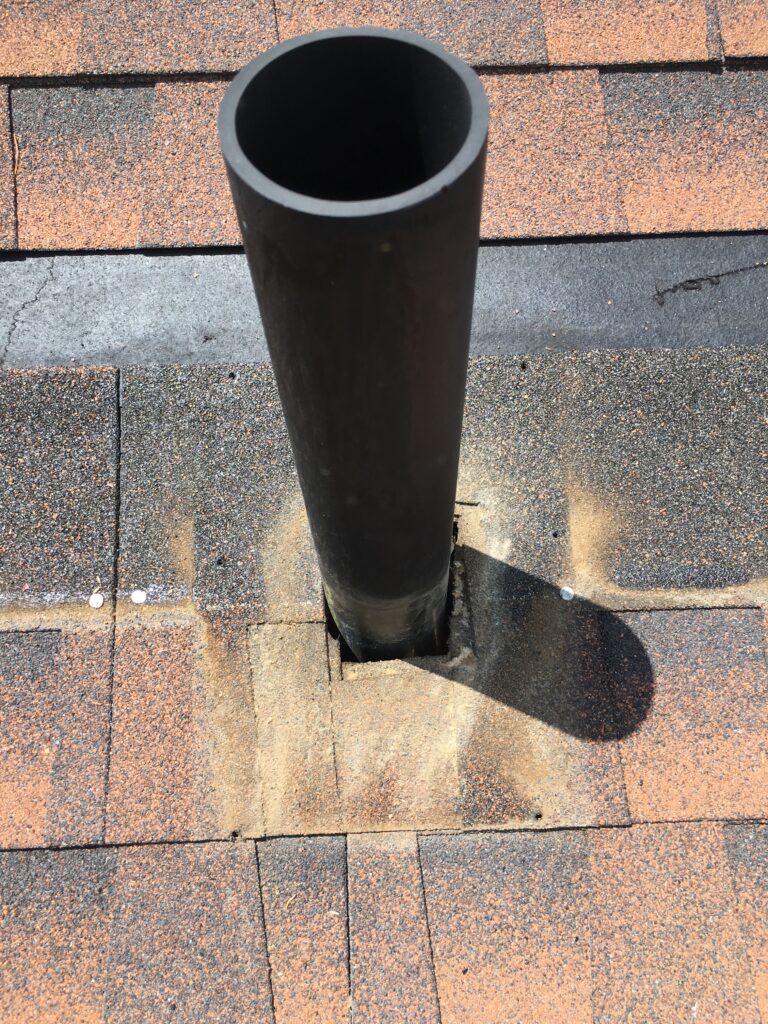 image shows an old pipe jack on a roof with the pipe flashing removed as part of a boulder roof repair
