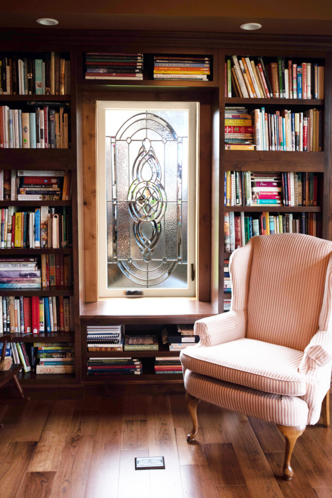ProVia Aeris Window in a library in behind a pink chair 