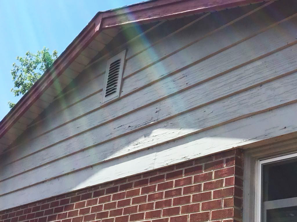 Old wood siding with chipping paint 
