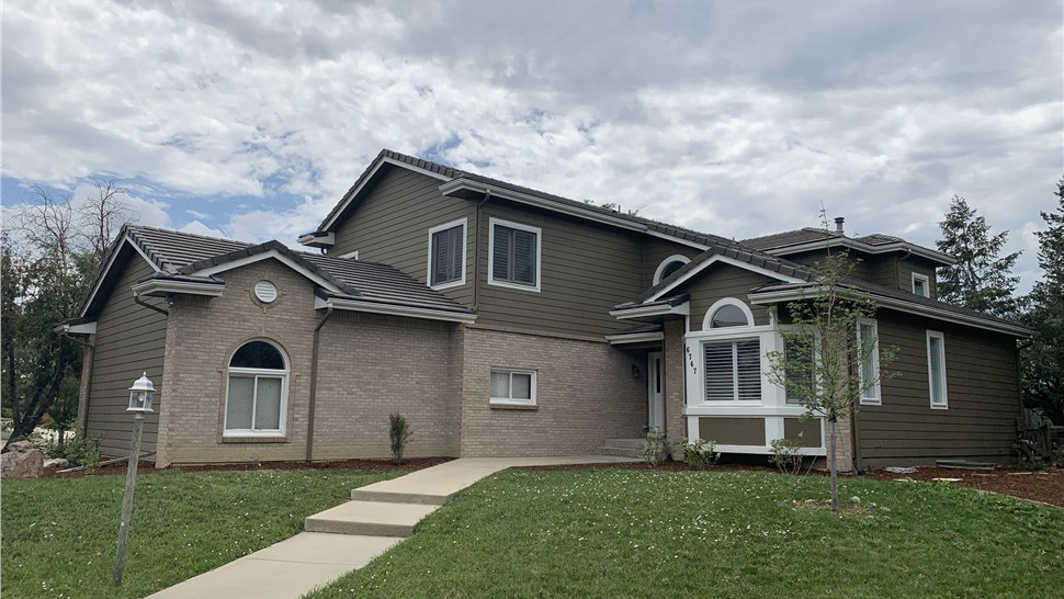 Full exterior of two-story home before window replacement in Longmont Colorado