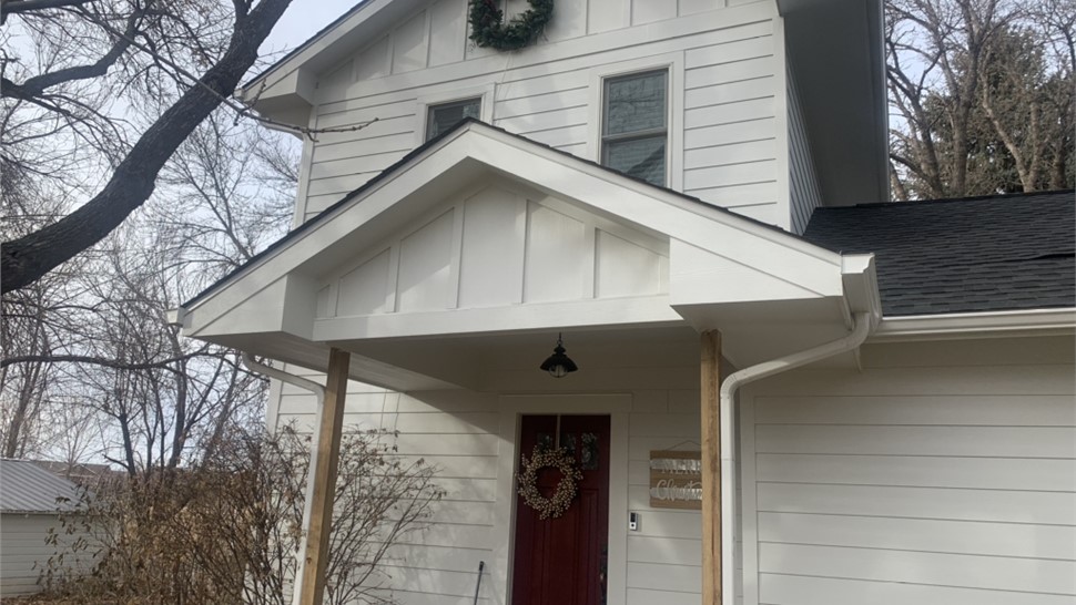 James Hardie siding installation with board and batten porch gable in Fort Collins Colorado