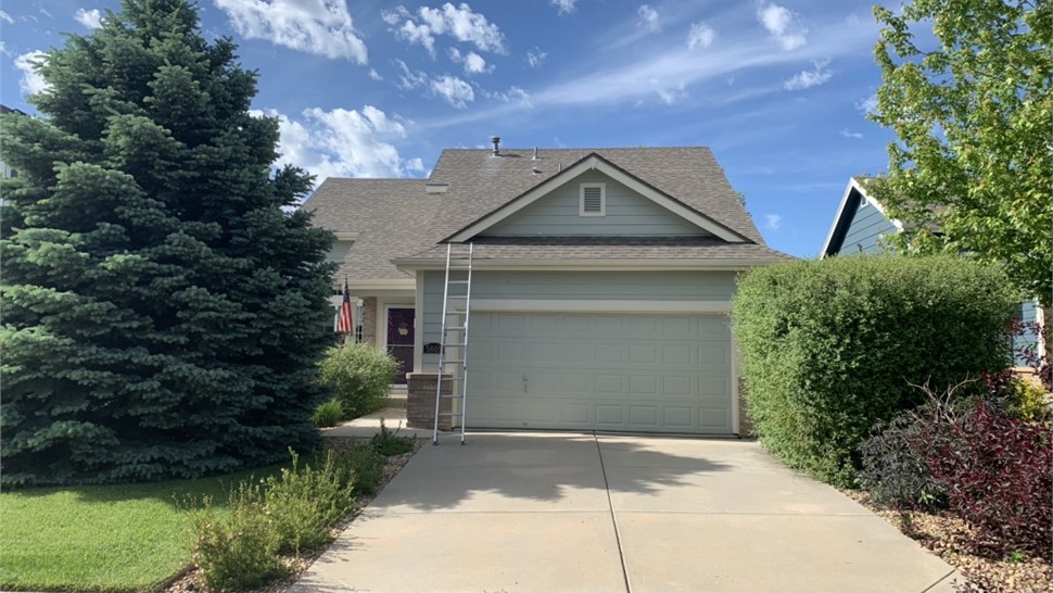 Hail-damaged asphalt shingle roof in Longmont, Colorado before replacement