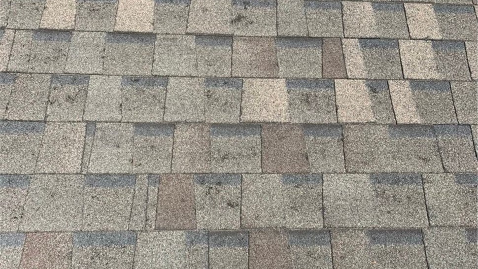 Hail damaged shingles view home in Erie Colorado with hail damage before roof replacement