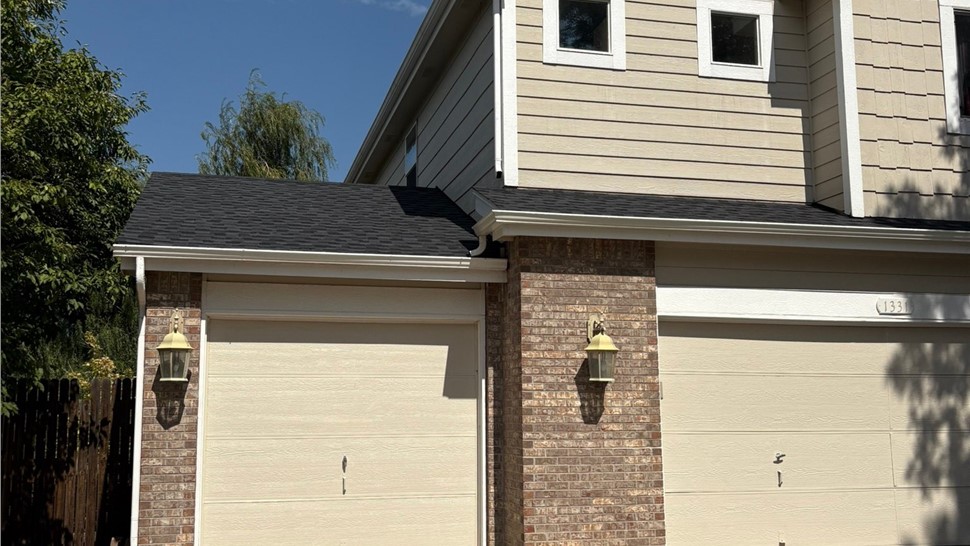 Full home view of complete roof replacement with GAF Armorshield II shingles in Charcoal on home in Erie Colorado