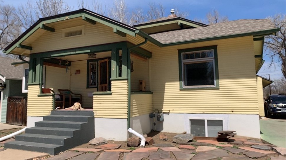Front porch of a 1928 Longmont home showing the original single-pane windows before replacement