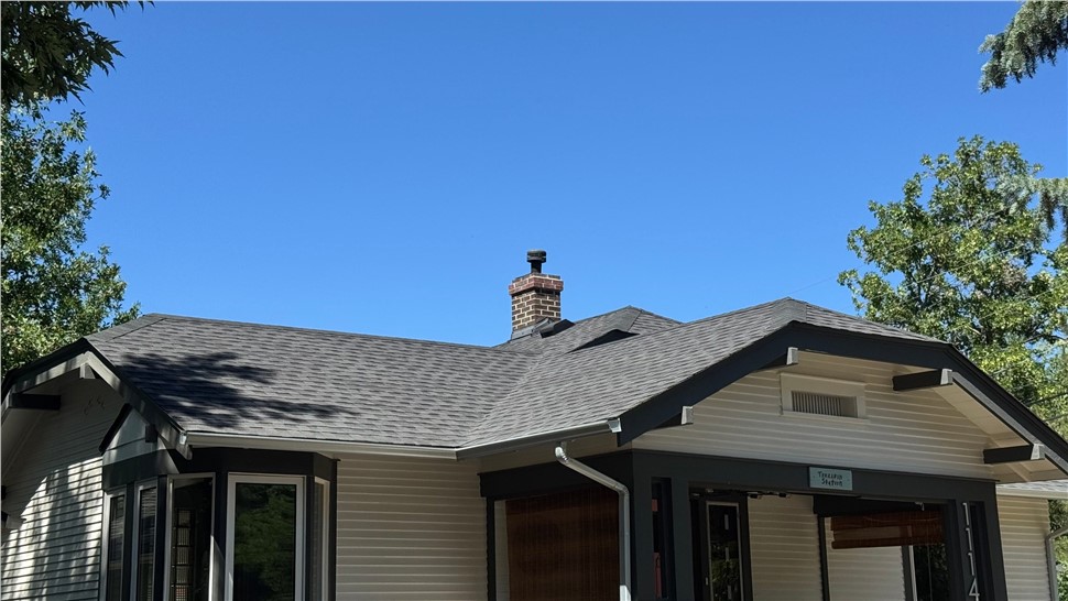 Roofline, chimney, and gutter edge of a Longmont home showing WestPro's new roof and gutters