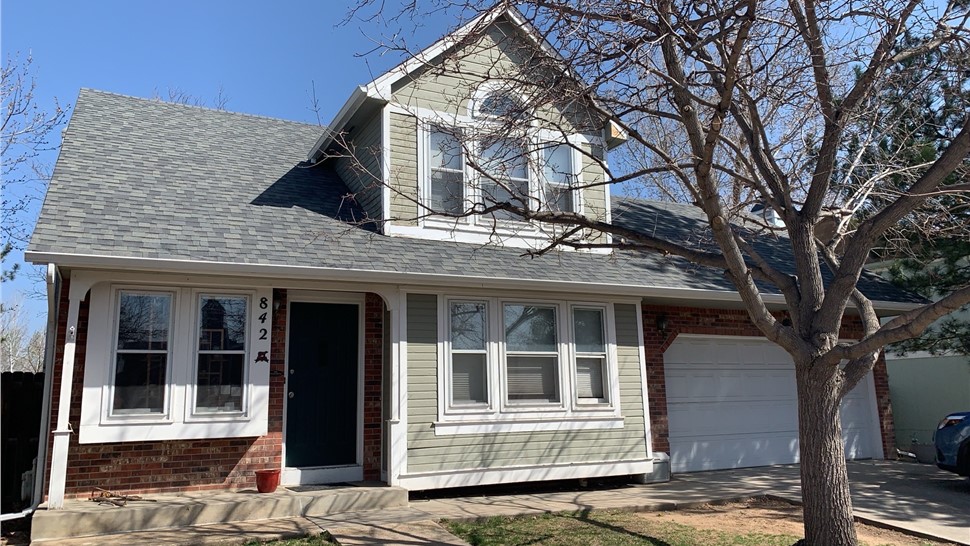Front elevation of a Fort Collins home with original wood siding before replacement
