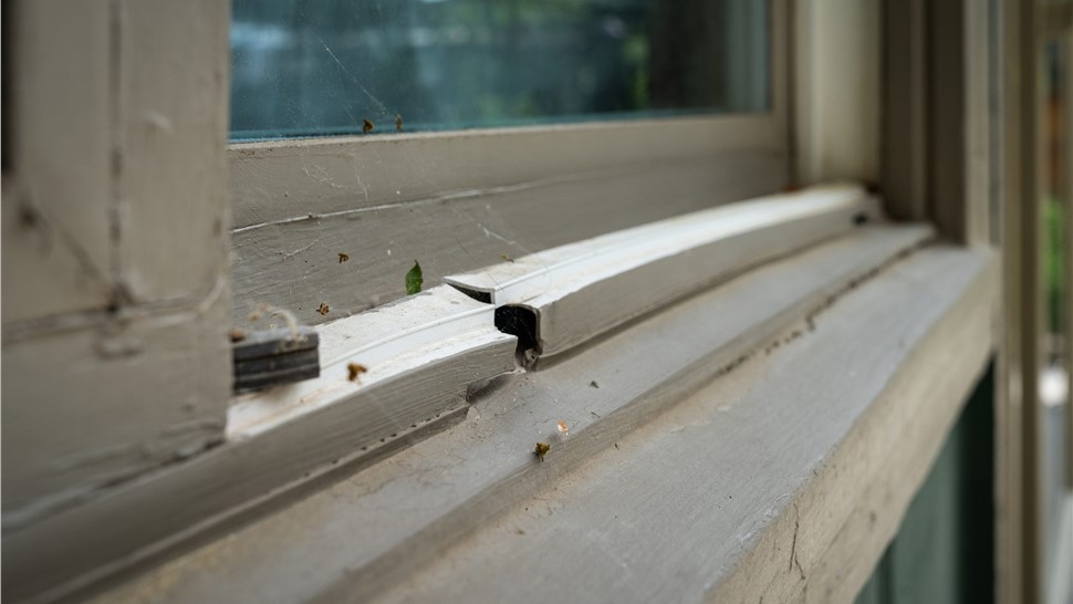 Close-up of a cracked sill track on an aging window in Longmont