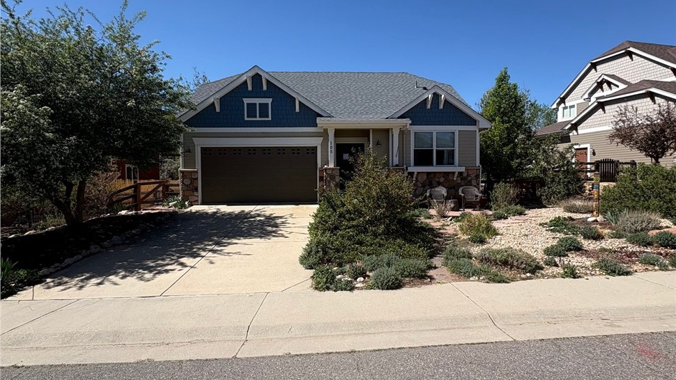 Full view of home after roof replacement with GAF Timberline Armorshield II shingles in Pewter Gray
