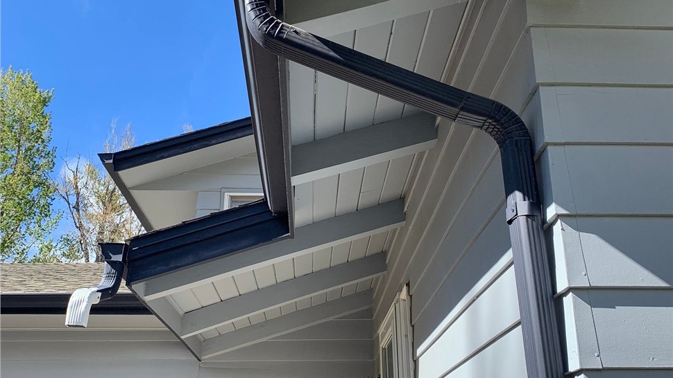 Cracked, old siding on Arvada Colorado home before siding replacement and gutter replacement