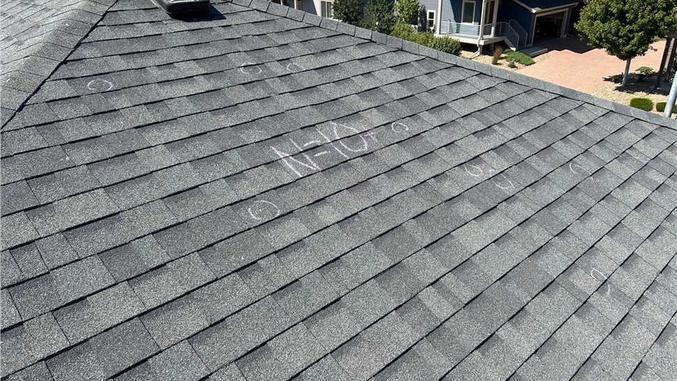 Hail damaged home in Denver Colorado before full roof and gutter replacement hail test square