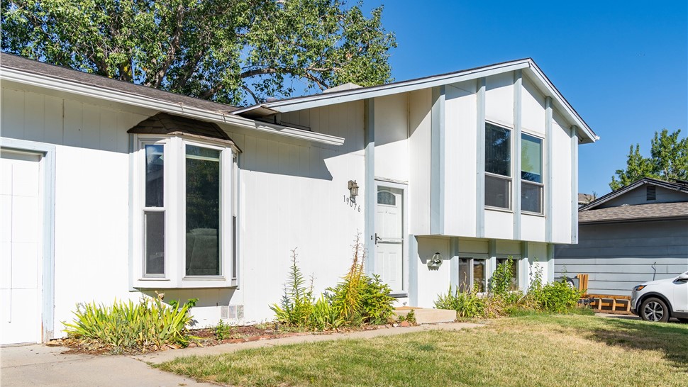 Golden Colorado home before a new James Hardie Board and Batten Installation in Arctic White with Iron Gray Trim