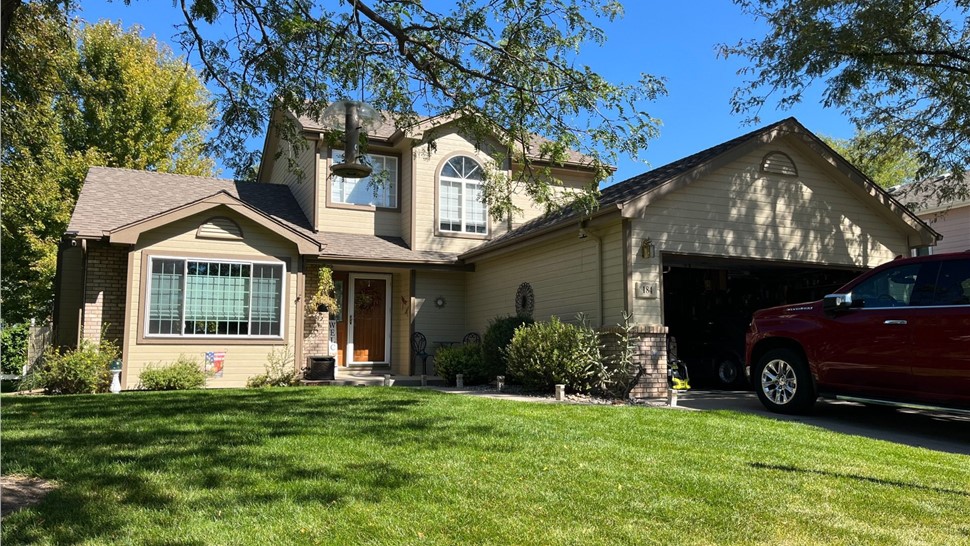 Water damaged siding and windows on home in Loveland Colorado before James Hardie and ProVia replacement