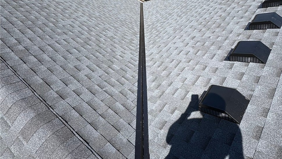 Rake view of home after roof replacement with GAF Timberline Armorshield II shingles in Pewter Gray