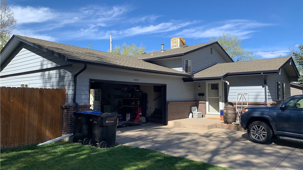 Cracked, old siding on Arvada Colorado home before siding replacement and gutter replacement