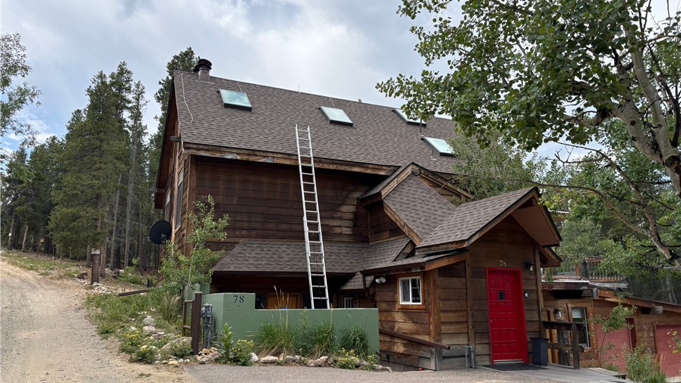 Front elevation of a Black Hawk mountain home with new GAF ArmorShield II shingles in Barkwood