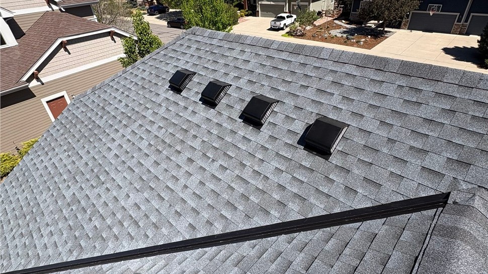 Wide view of home after roof replacement with GAF Timberline Armorshield II shingles in Pewter Gray