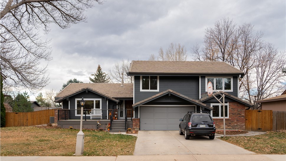 Multi-level Longmont home with Iron Gray James Hardie lap siding, white trim and a brown tile roof