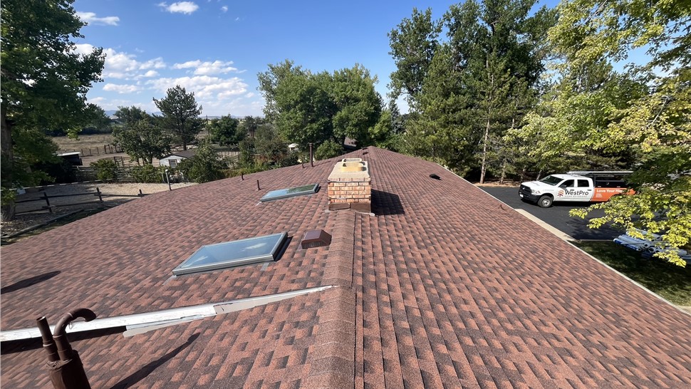 New roof ridge with skylights and chimney flashing in Longmont Colorado