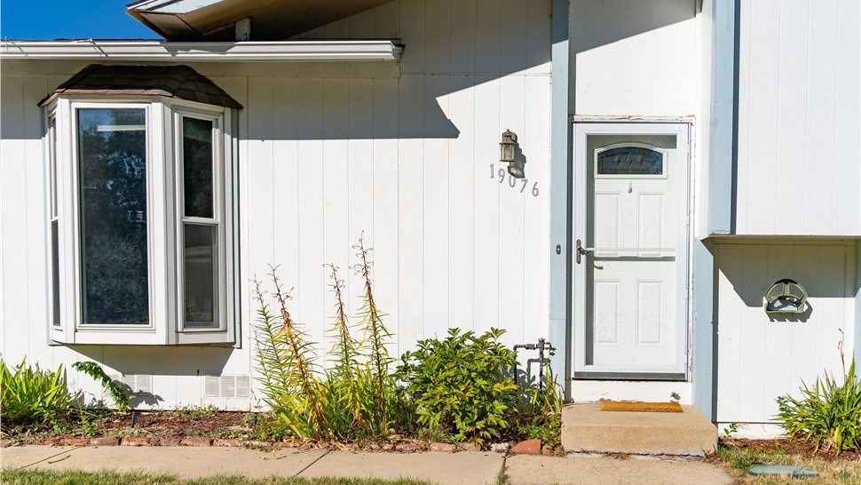 Golden Colorado home before a new James Hardie Board and Batten Installation in Arctic White with Iron Gray Trim