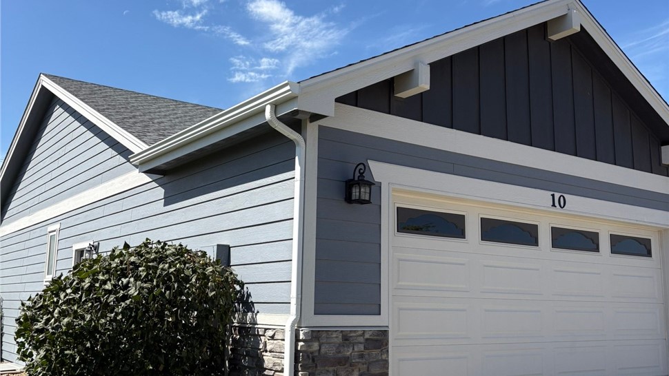 Front elevation of an Eaton, Colorado home with new roof and gutters