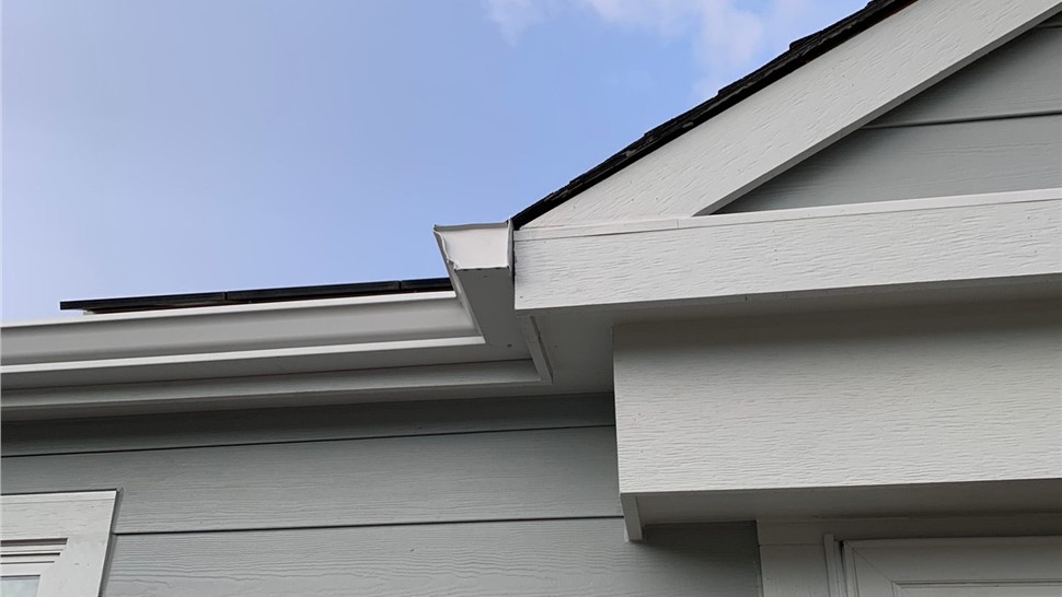 Detailed close up of James Hardie Light Mist Lap Siding and new gutter system on home in Lafayette Colorado
