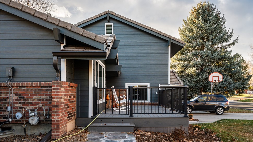 Iron Gray Hardie siding beside a brick column and front deck in Longmont