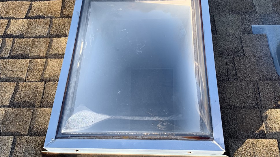 Failing skylight with fogged glass and rust staining before replacement in Boulder Colorado