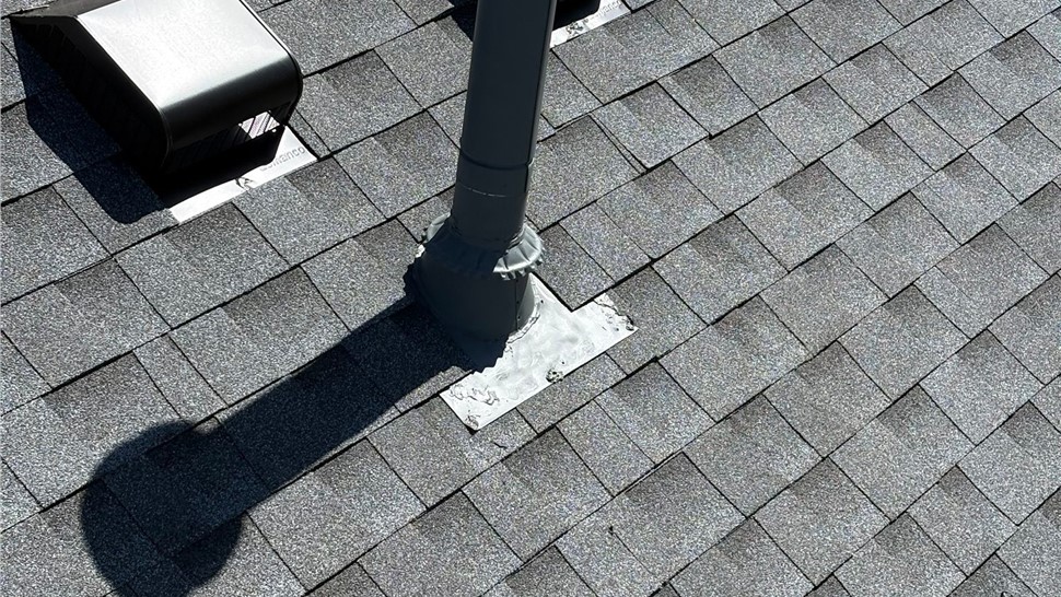 Close up view of ventilation on home after roof replacement with GAF Timberline Armorshield II shingles in Pewter Gray