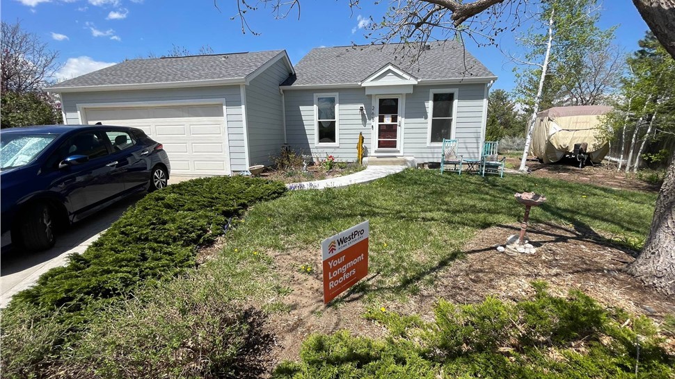 Full view hero shot of home in Lafayette Colorado after James Hardie siding replacement and GAF roof replacement with new gutter system