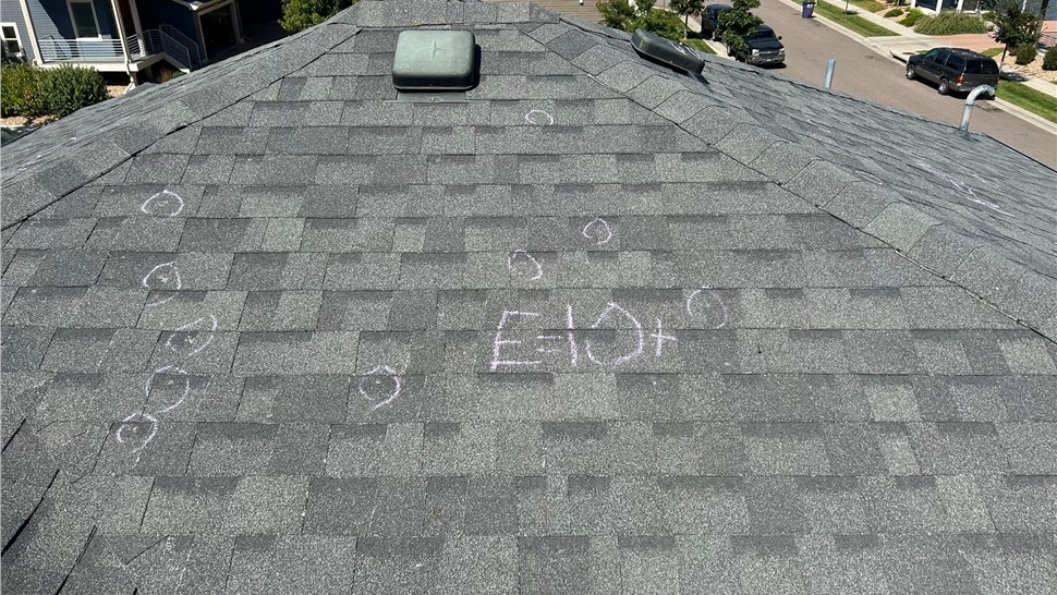 Hail damaged home in Denver Colorado before full roof and gutter replacement hail test square