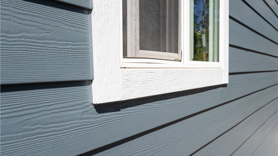 New window trim and James Hardie Evening Blue siding detail on a Boulder home