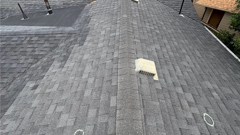 ridge line view of home with hail damaged roof in louisville colorado