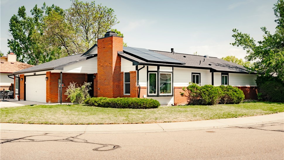 James Hardie Arctic White siding, Charcoal shingle roof, and black-trimmed windows on completed Longmont home