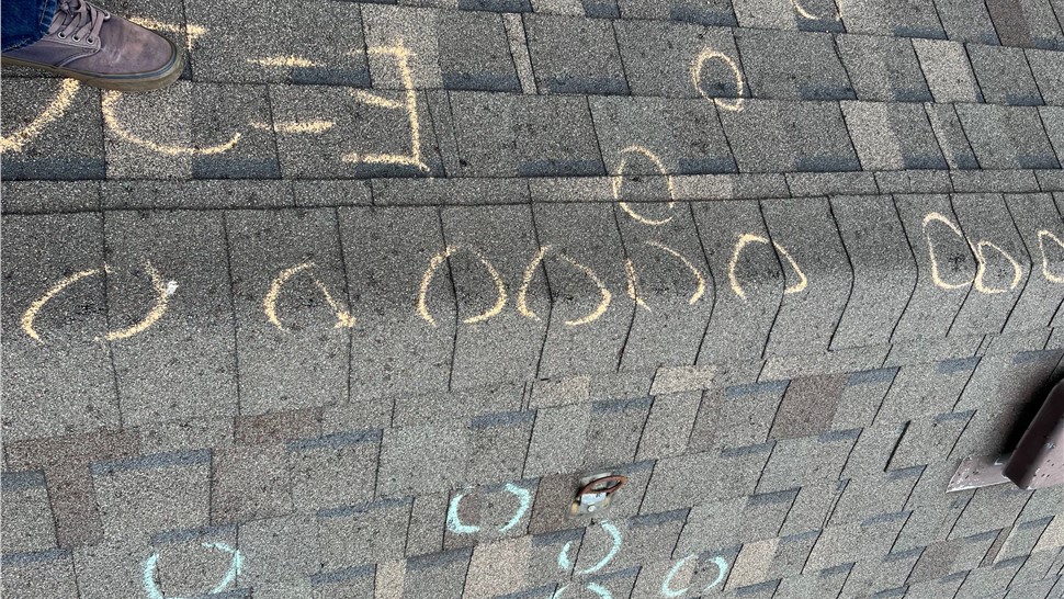 Chalk test square showing amount of hail hits on hail damaged roof in Erie Colorado before replacement
