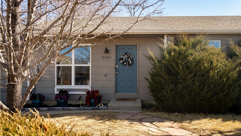 Entry before Longmont siding renovation with new entry door and windows