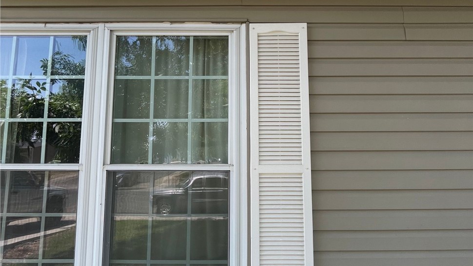 Siding, gutters and roofline before exterior remodel of Thornton home