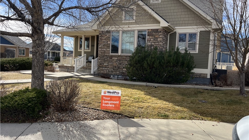 Completed roof replacement with WestPro yard sign in front of a Longmont, Colorado home