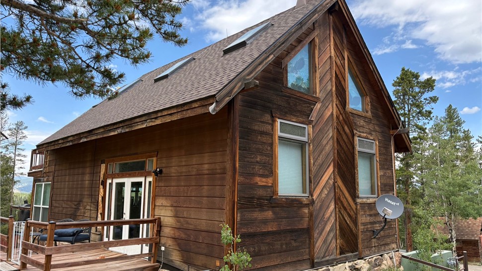 Side elevation of a Black Hawk home with new GAF ArmorShield II roof in Barkwood