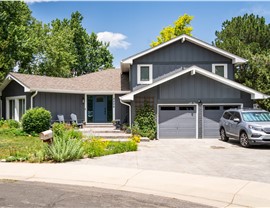 Boulder Home after full reside, window and entry door replacement with all new trim, soffit, fascia and gutters, in primed and painted James Hardie Board and Batten