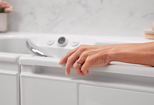 A hand on a white sinkAI-generated content may be incorrect.