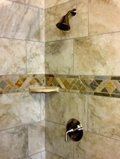 Photo of a shower wall made of tile.
